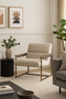 Modern living room with beige armchair, side table, and decor elements.